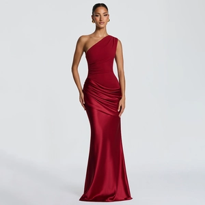 Detail of red one-shoulder evening gown featuring elegant satin pleats and draping