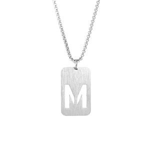 Detailed macro view of silver steel rectangle pendant with hollow M letter and box chain