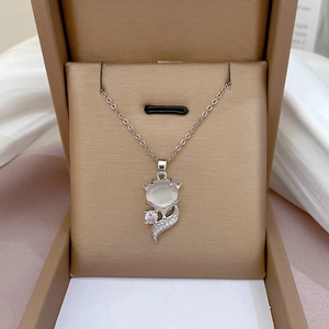 Silver fox necklace with cat eye stone and tiny diamonds in a brown jewelry box