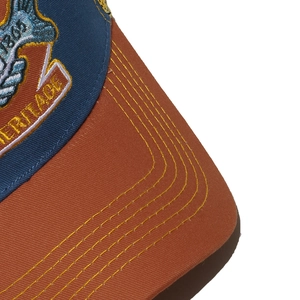 Macro view of vintage trucker hat with heritage embroidery and yellow stitching details