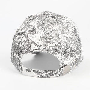 Detail view of the baseball cap's back with a metal adjustment buckle and ink art texture