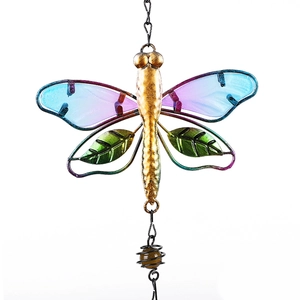 Detail of metal dragonfly wind chime with colorful glass wings and green leaf ornament