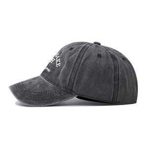 Detailed side view of washed dark grey cotton baseball cap with white printed lettering