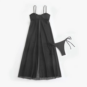 Detail view of black mesh cover-up dress and side-tie thong bikini set on white background