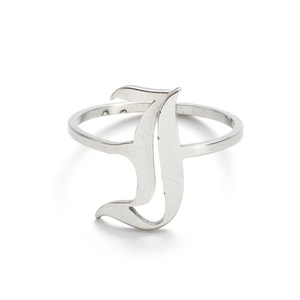 Macro shot of silver gothic letter I ring featuring authentic material hallmarks on inner band
