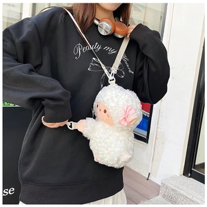 Detailed view of white plush lamb crossbody bag with pink bow and adjustable strap