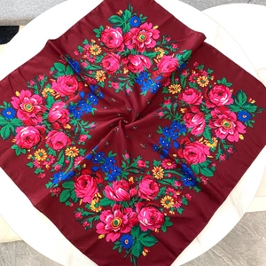 Detailed view of red floral cotton scarf with Russian folk style rose patterns
