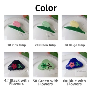 Close-up of acetic tulip hair claws and floral shark clips in vibrant color variants