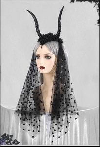Detail of gothic black sheep horns headband with polka dot mesh veil and dark flowers