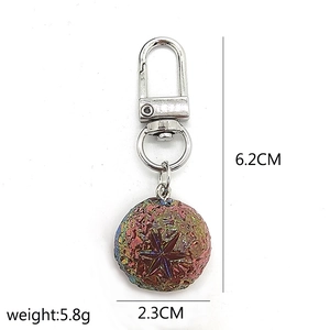 Rainbow plated ball keychain with star texture and lobster clasp details shown on white background