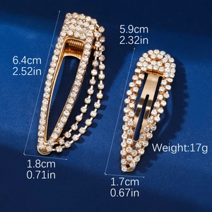 Detail showing two gold rhinestone hair clips with fringe chain and exact dimensions
