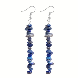Detailed close-up of handmade drop earrings featuring irregular blue natural lapis stones