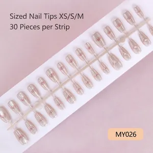 Close-up of pink cat eye press-on nails with 3D heart design in multiple sizes