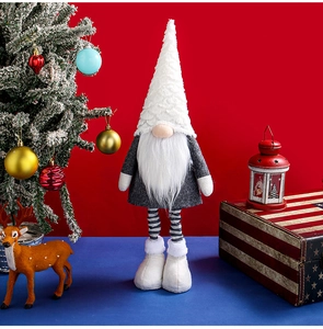 Detail of plush Christmas gnome with red hat in a festive setting with ornaments