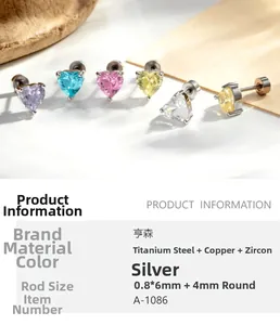Macro detail of heart-shaped zircon earrings with steel screw backs and size specifications