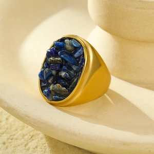 Close-up of vintage gold ring with irregular dark blue lapis lazuli stone inlay