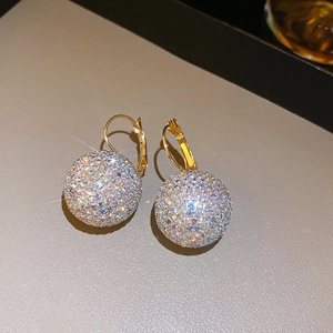 Detailed view of gold ball drop earrings with colorful sparkling rhinestones