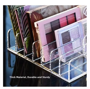 Close-up of 7-slot transparent acrylic makeup organizer with thick edges for eye palettes