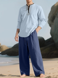 Detail of light blue linen shirt with decorative neckline and dark blue casual trousers