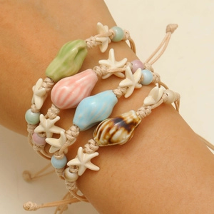 Adjustable ocean themed handmade woven bracelets with ceramic conch and starfish charms