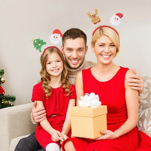 Family wearing festive Christmas headbands featuring Santa, reindeer and tree designs