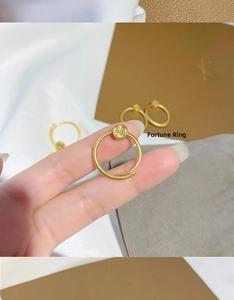 Detailed macro view of 18K gold-plated rotating ring with engraved Fu character and matte finish
