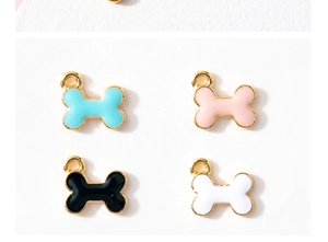 Detail of four colorful enamel bone pendants for DIY jewelry making in gold plating
