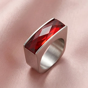 Detailed macro view of a luxury silver ring featuring a large rectangular red gemstone inlay