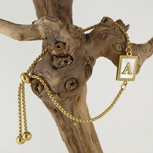18k gold plated stainless steel box chain bracelet with letter A shell pendant on wood