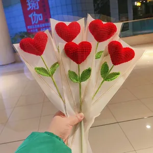 Handmade crochet heart bouquet with red knitted hearts and white decorative wrapping paper