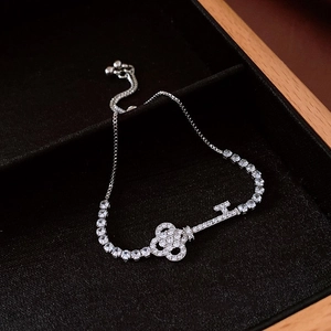 Close-up of zircon geometric key bracelet with silver chain in a luxury jewelry box