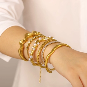 Adjustable gold plated bangle set with pearls and zircons on female wrist