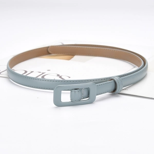 Women's light blue genuine leather belt with matching rectangle buckle on a magazine