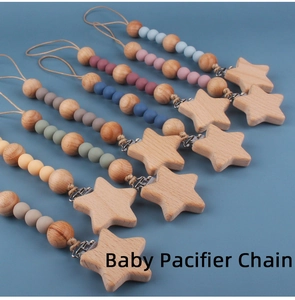 Multiple beech wood baby pacifier chains with colorful silicone beads on blue background