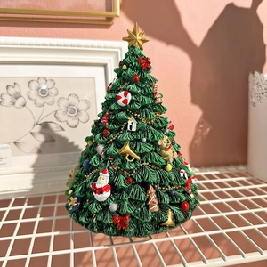 Rotating musical Christmas tree ornament with Santa and bells on a grid stand