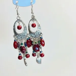 Elegant silver drop earrings with red round beads and colorful beads in ethnic style