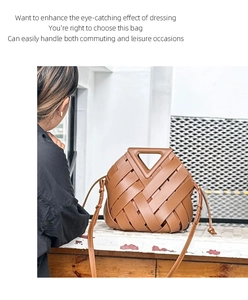 Close-up of brown woven leather handbag with triangular handle and long shoulder strap