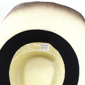 Macro detail of paper straw woven hat interior with sweatband and washing label