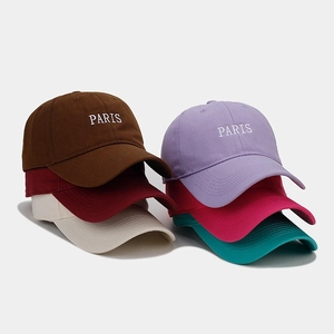 Detailed stack of multi-color cotton baseball caps with high-quality PARIS embroidery