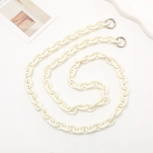 Close-up of cream acrylic chunky crossbody chain with silver metal spring ring clasps