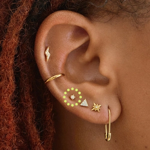 Detailed view of gold S925 silver ear studs featuring opal and starburst designs