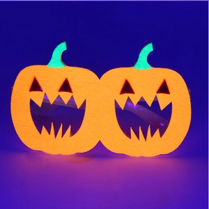 Detailed view of pumpkin-shaped Halloween felt glasses with vibrant orange and green accents