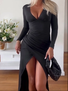 Detail of slim-fit black maxi dress featuring V-neckline, ruched waist and high leg slit