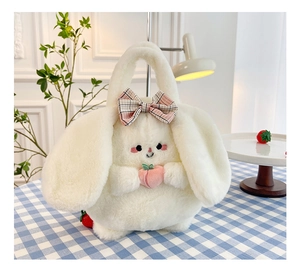 Detailed view of white plush rabbit bag with pink plaid bow and a small peach detail