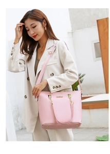 Pink PU leather tote bag with gold chain strap shown on beige blazer in sunlight