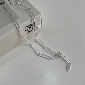 Handmade 925 sterling silver paperclip chain choker necklace on a gift box background