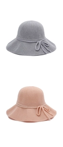 Detail of grey and pink breathable straw bucket hats with woven ribbon bow accents