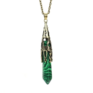 Detail of green malachite hexagonal pendant necklace with antique bronze flower cap