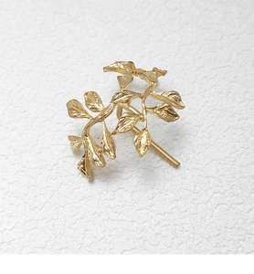 Close-up of elegant gold leaf hair hook accessory with detailed metallic texture