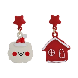 Detail of Christmas earrings featuring a cloud with Santa hat and a red winter cottage